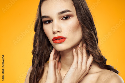 beautiful brunette red lips bare shoulders skin care yellow background