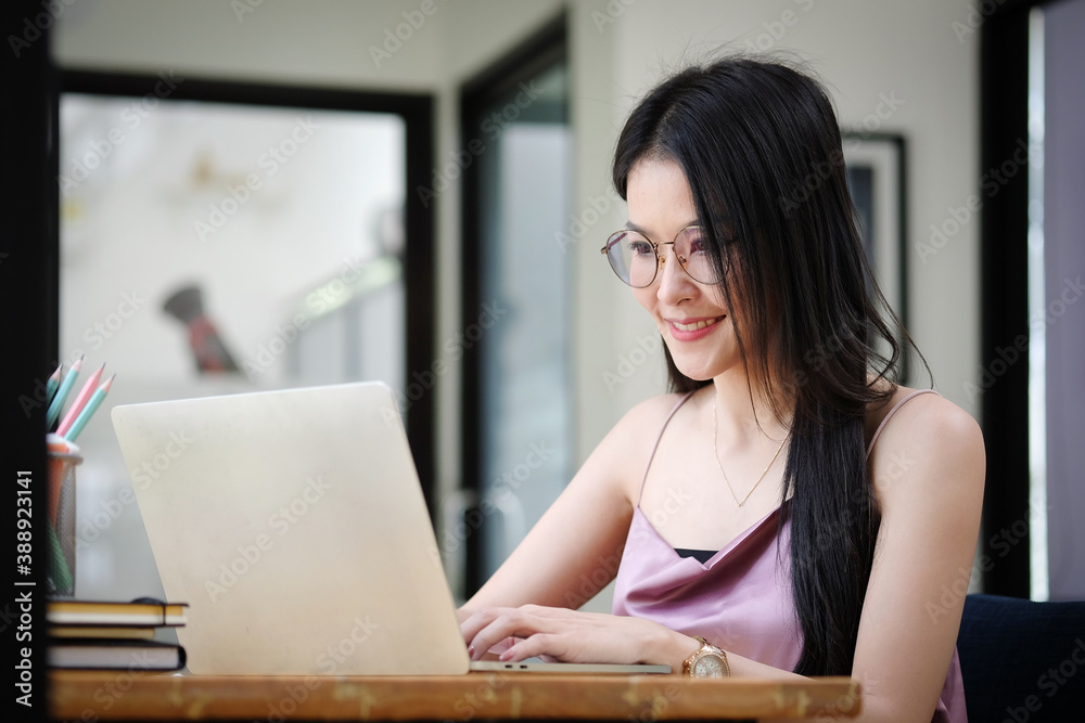 Experienced businesswoman reading publication via laptop computer making research for planning startup at desktop in modern office. Experienced businesswoman reading publication via laptop computer making research for planning startup at desktop in modern office.