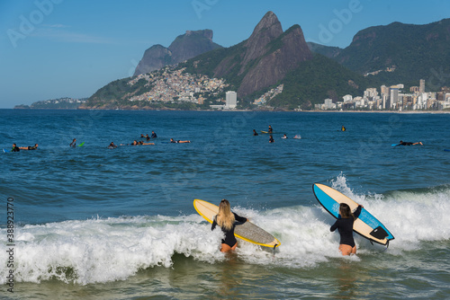 Two Female Surfers Entering the Ocean With Surfboards at Ipanema Beach in Rio de Janeiro, Brazil