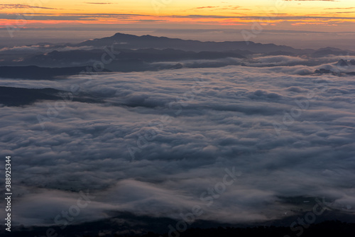 Rainy season with foggy at morning, Mountain top view of sunrise landscape in the rainforest, Thailand.