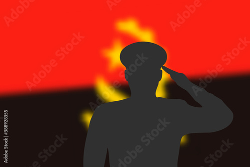 Solder silhouette on blur background with Angola flag.