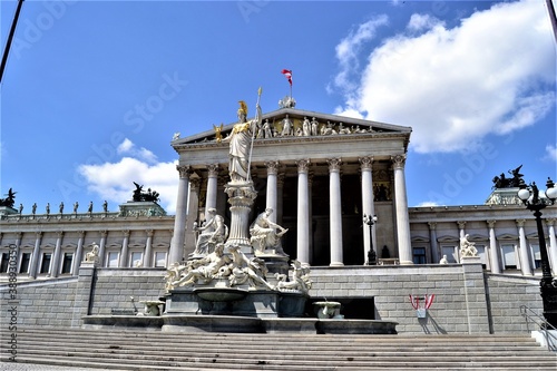 Vienna during sunny day and important statue. The Parliament Building of Austria with blue sky. Location in Vienna. Capital city of Austria