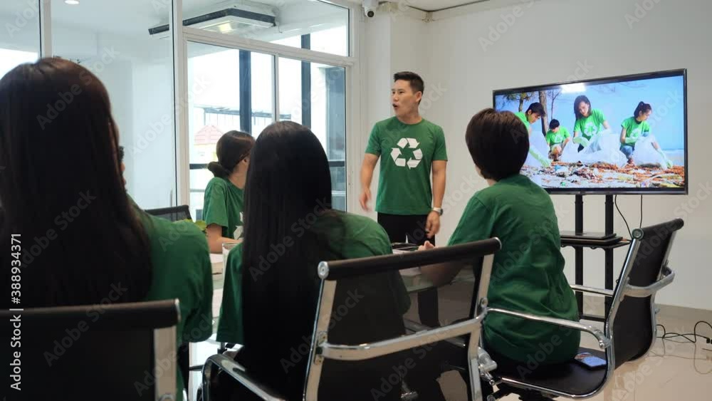 Volunteer team meeting and presentation of working together. Volunteer man and woman brainstorm ideas resolve about waste beach. Team campaigners collaborating work for next summer.