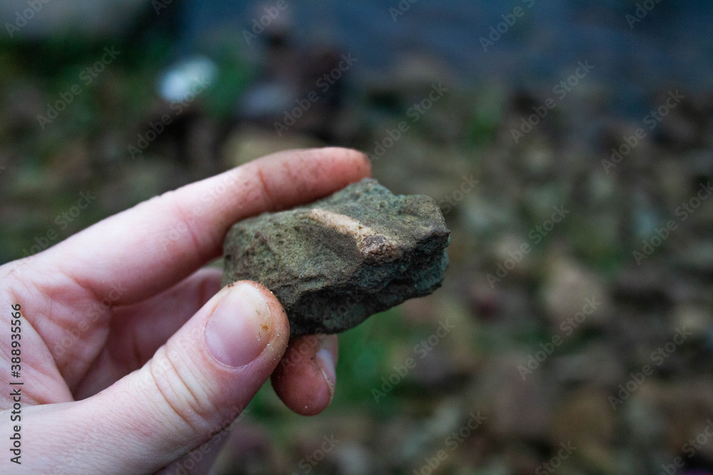 hand holding a stone hand holding a stone