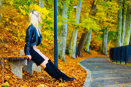 Fashion woman relaxing in autumn park photo