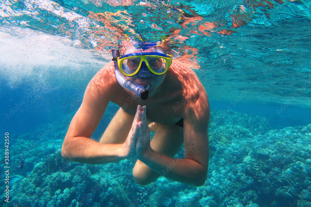 Fototapeta premium Underwater shot. Man diving with scuba in a tropical sea. Travel lifestyle, outdoor water sport adventure, swimming lessons on summer beach vacation