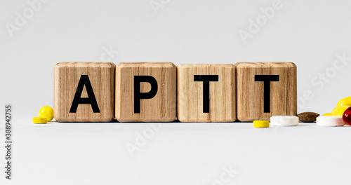 cubes with the word APTT on them. Care concept. photo