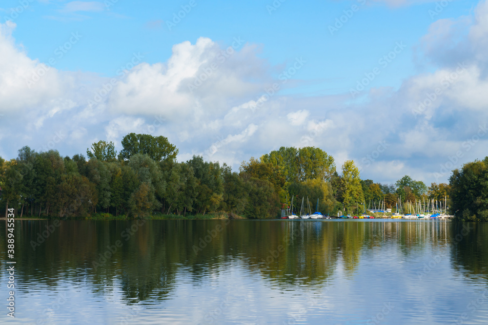 View from the lake to the forest and the bay for the sailing yachts. View from the lake to the forest and the bay for the sailing yachts.