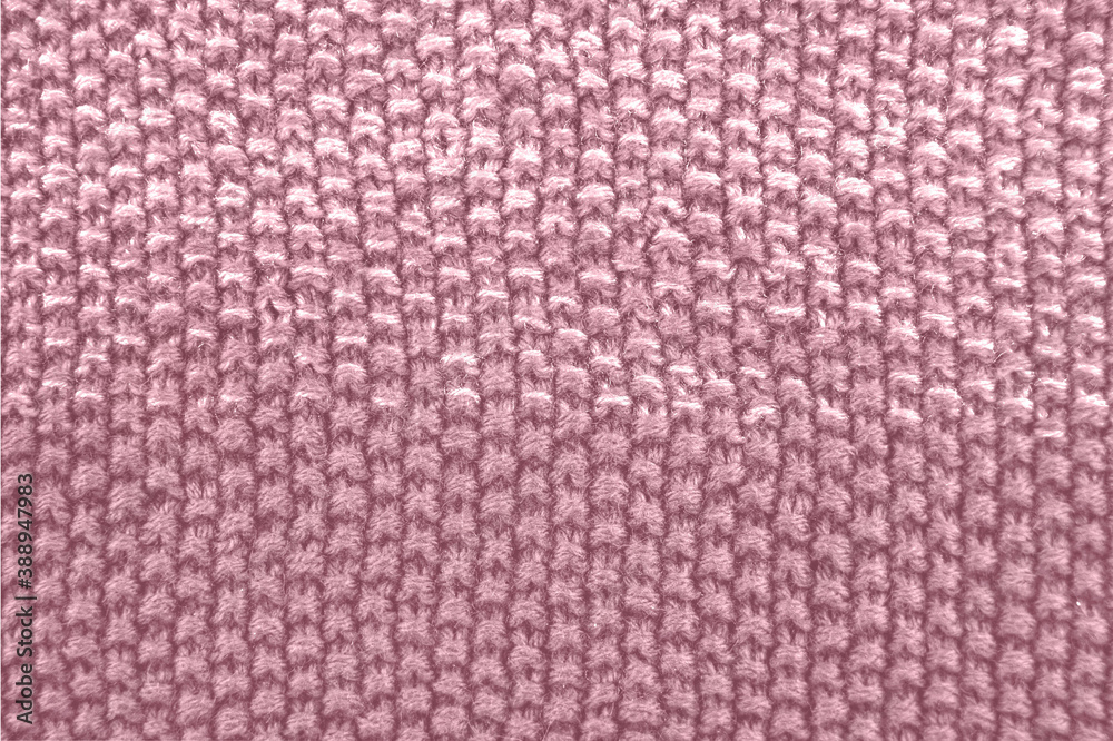 Knitted texture in pink color. Close up.