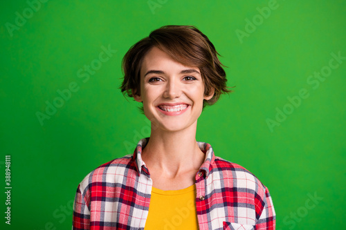 Close up photo of delighted young person smile look camera wear plaid isolated on green color background © deagreez