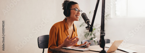 Fotografija Female podcaster making audio podcast from her home studio