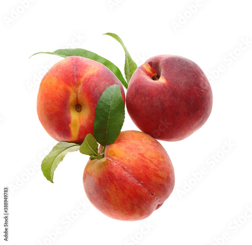 Delicious ripe juicy peaches with leaves isolated on white, top view