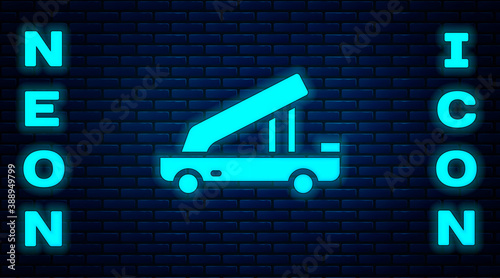 Glowing neon Passenger ladder for plane boarding icon isolated on brick wall background. Airport stair travel. Vector.