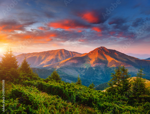 Exotic landscape in the mountains at sunset. Picture of colorful cloudy sky.