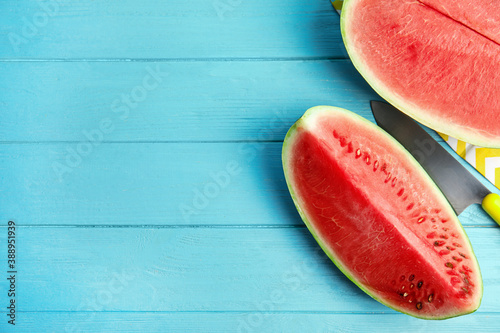 Yummy cut watermelon on light blue wooden table, flat lay. Space for text
