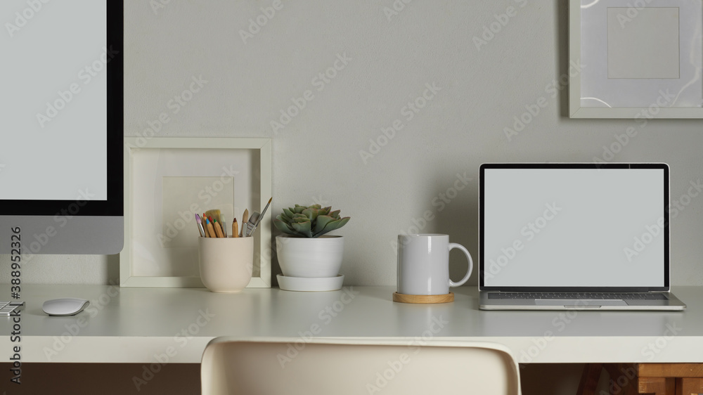 Worktable with computer, laptop, decorations and copy space, clipping path Worktable with computer, laptop, decorations and copy space, clipping path