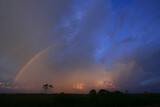 Twilight with a rainbow against a background of clouds and blue sky