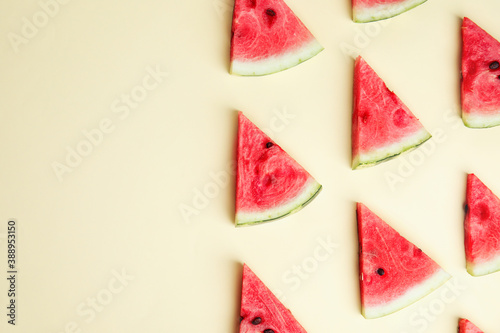 Slices of ripe watermelon on beige background, flat lay. Space for text