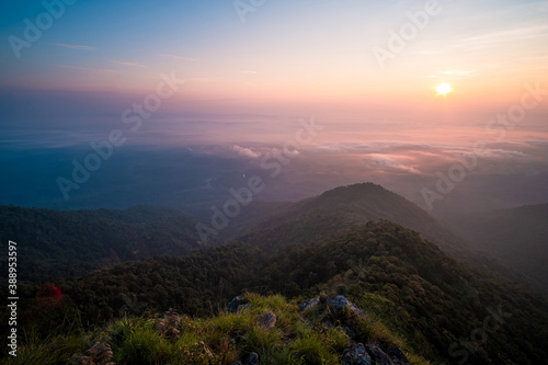 Beautiful sunrise over the mountain range and sea clouds