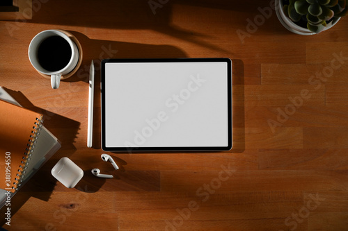 Wooden table with digital tablet, accessories, coffee cup and copy space, clipping path