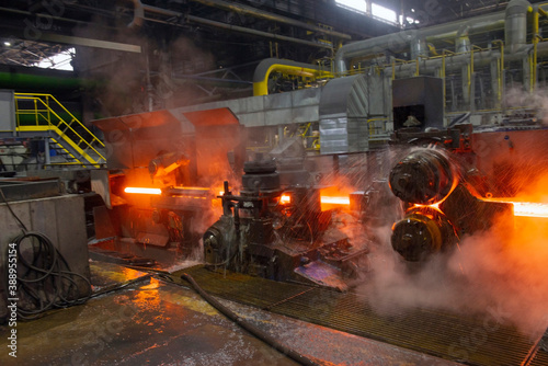 hot steel on conveyor in a steel mill. hot rolled rebar