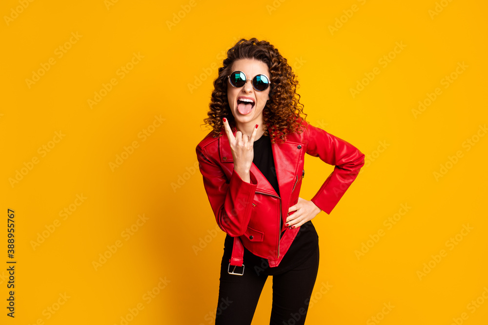 Fototapeta premium Portrait of crazy girl show horned symbol show tongue wear pants isolated on bright shine color background