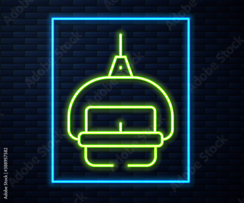 Glowing neon line Ski lift icon isolated on brick wall background. Vector.