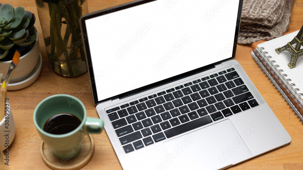 Workspace with laptop, coffee mug and stationery in home office, clipping path Workspace with laptop, coffee mug and stationery in home office, clipping path