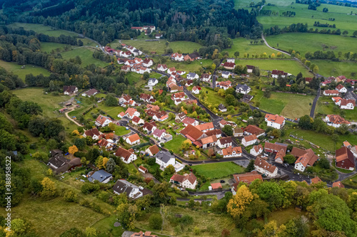 Aerial view of a village situeted in a valley of the mountain area Rhoen in autumn, Hessia, Germany. photo