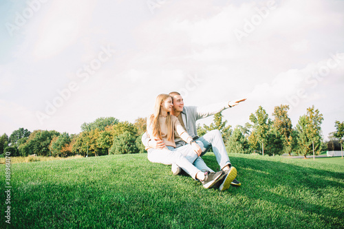 Young couple resting on the green lawn in the park. Stylish photo © Владислав Легір