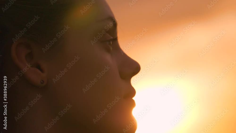 Portrait of a happy young teenager girl on the street. The girl dreams with pleasure with her eyes closed. The lady feels free, successful, ready to start the day, move forward. Portrait of a happy young teenager girl on the street. The girl dreams with pleasure with her eyes closed. The lady feels free, successful, ready to start the day, move forward.