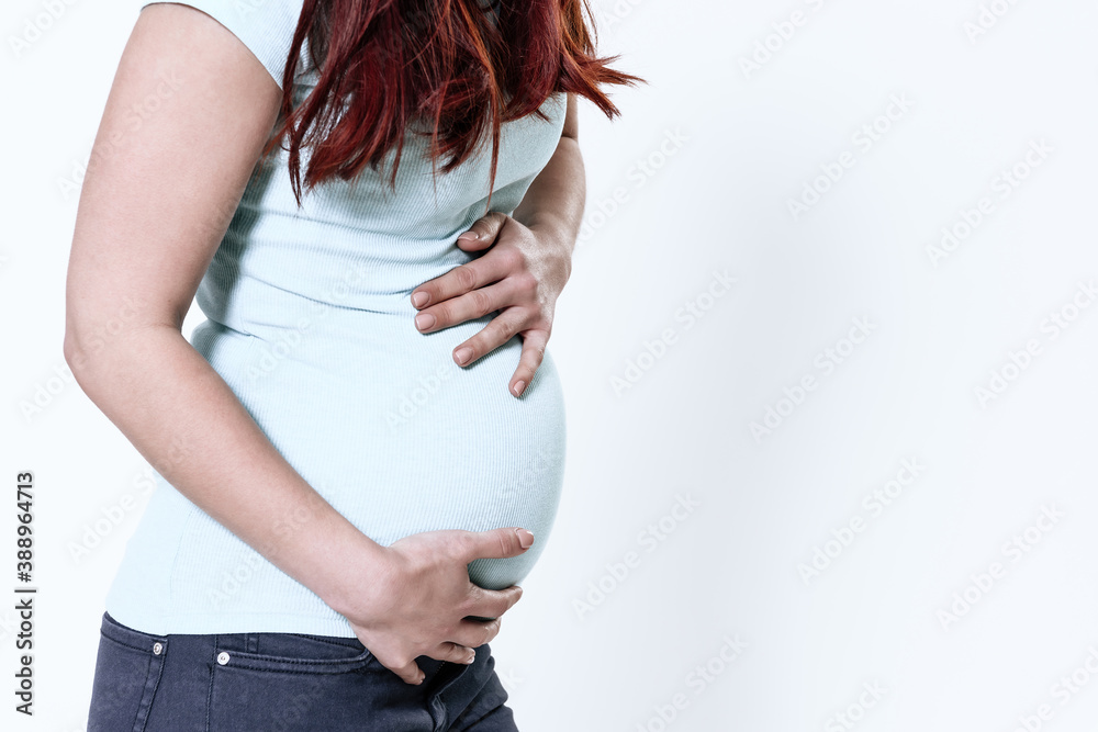 A girl with bloating is standing and feeling pain. A girl with bloating is standing and feeling pain.