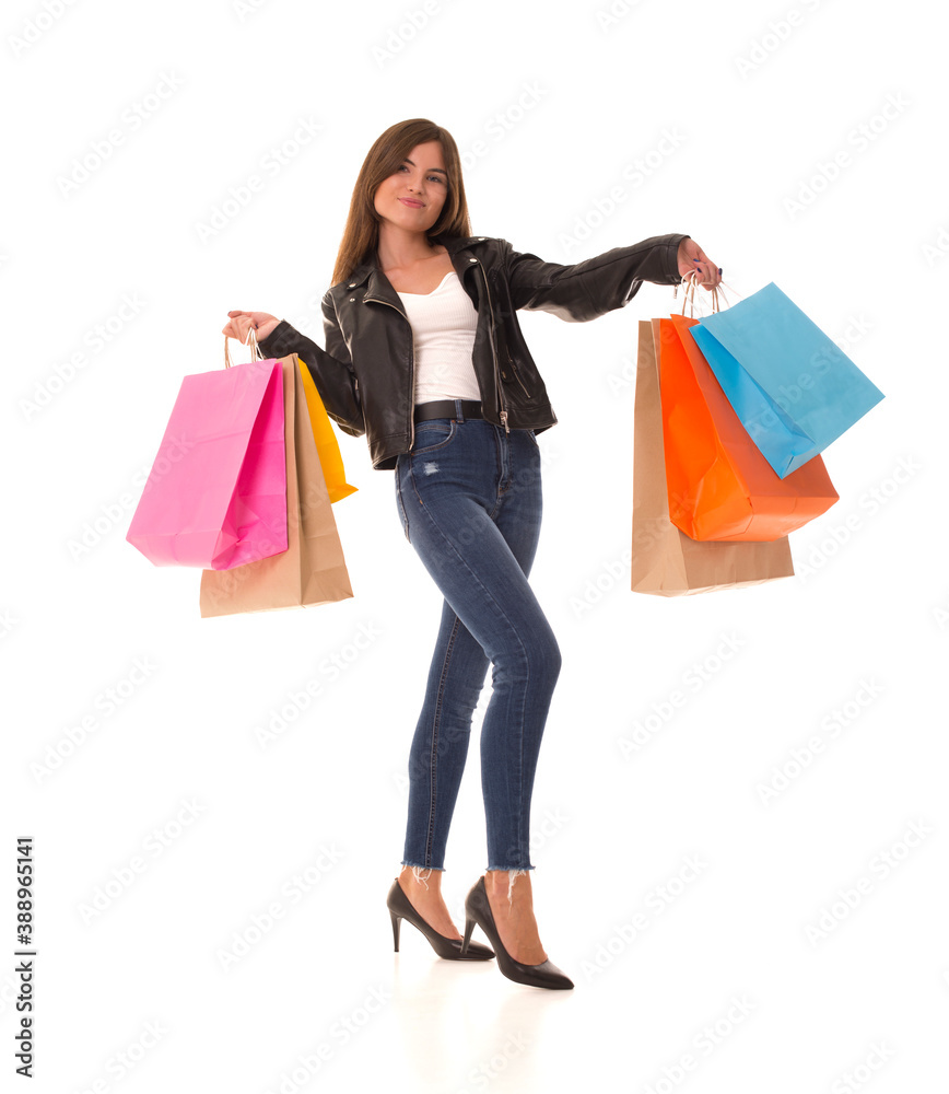 Girl after shopping stands with packages in her hands and smiles. Girl after black friday posing on camera. 