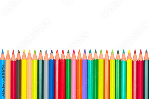 Colourful wooden school pencils (crayons) in a row isolated on white background. Educational concept