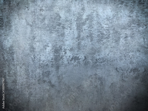 Grunge style. Close-up photo of concrete texture detail, There is a vignette at the corner of the image and a bright spot in the center is a copyspace. The gray and dark cement background is old.