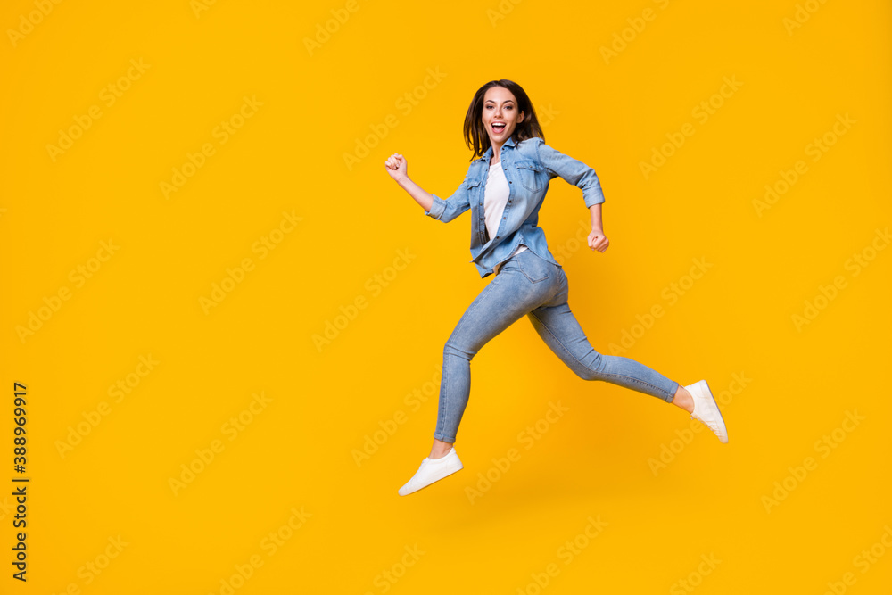 Full length body size profile side view of her she nice attractive cheerful cheery girl jumping running fast black friday discount isolated bright vivid shine vibrant yellow color background