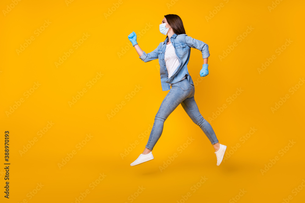 Full length body size profile side view of her she nice attractive active motivated girl wearing safety gauze mask jumping running marathon isolated bright vivid shine vibrant yellow color background
