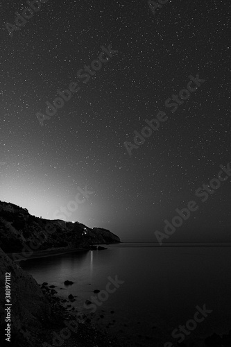 starry sky at night above the mountains with the constelations in background in black and white