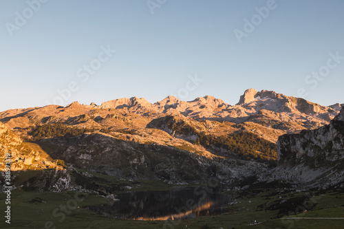 Peaks of Europe during the sunset with the lake in the middle