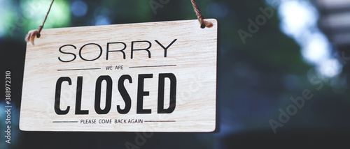 sorry closed sign on shop door. Text on cafe front or restaurant hang on door at entrance. vintage tone style. photo
