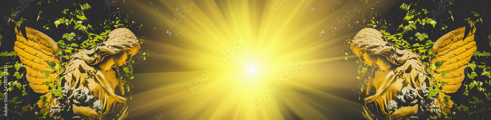 Two gold angels in sunlight. Ancient statues. Two gold angels in sunlight. Ancient statues.