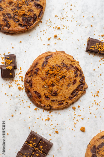 Homemade cookies with chocolate chips and speculoos on white marble background. Top view.