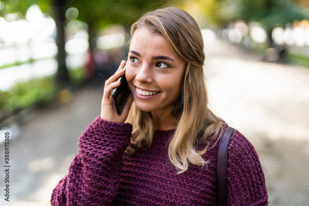 Young woman talking on mobile phone in the street Young woman talking on mobile phone in the street