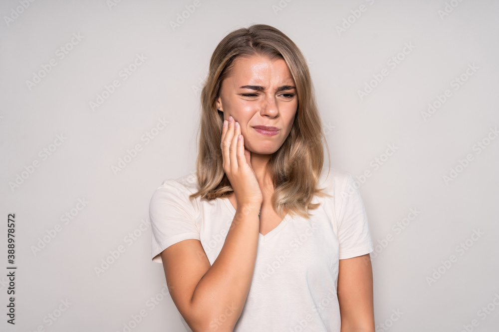 Portrait of young woman with toothache isolated on white background Portrait of young woman with toothache isolated on white background