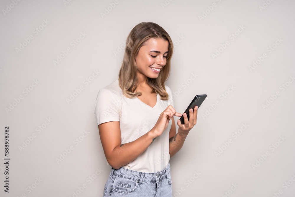 Beauty young woman using and reading a smart phone isolated on a white background Beauty young woman using and reading a smart phone isolated on a white background