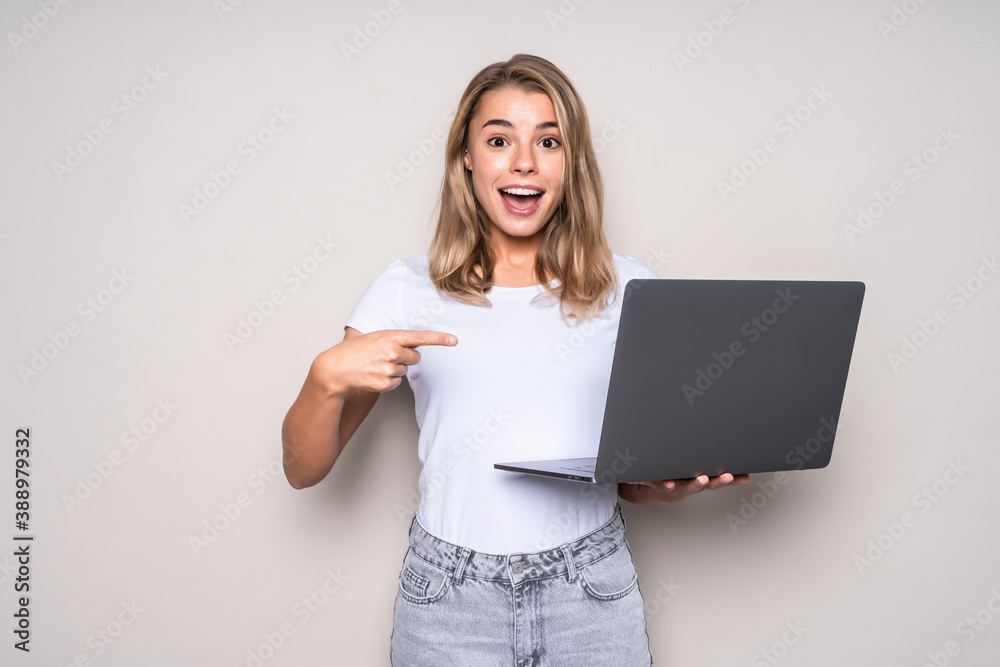 Beautiful young woman pointed on laptop isolated on white background Beautiful young woman pointed on laptop isolated on white background