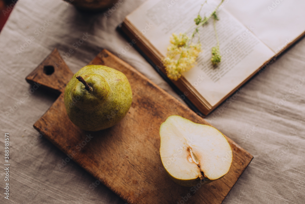 Stylish still life with pears and a book in rustic style.
