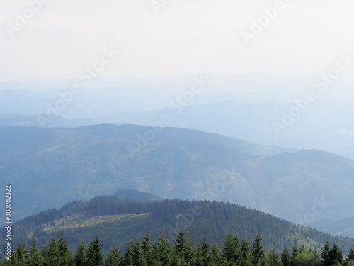 view from the Lysa hora mountain of the mountain landscape on a sunny summer day, hiking and traveling © vendulak
