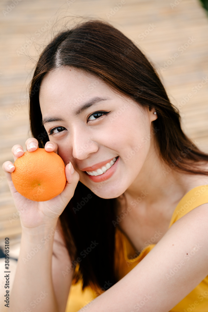 Portrait of young asian woman black hair with orange fruit. Portrait of young asian woman black hair with orange fruit.