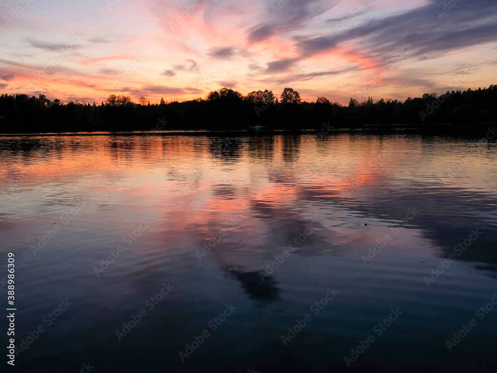 Beautiful sunset reflected in water of lake